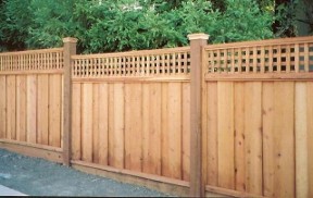 Cedar privacy fence with a square lattice top and capped posts